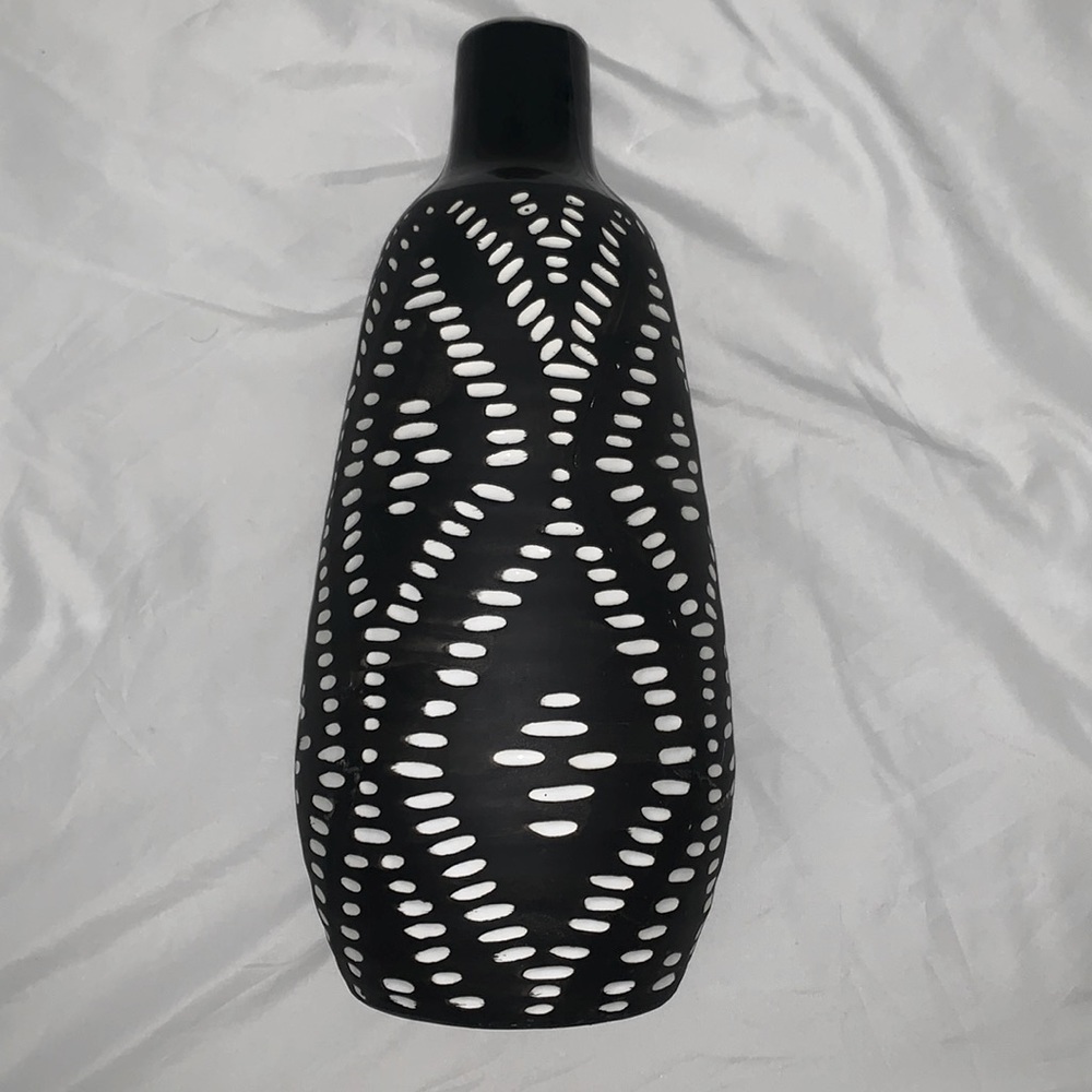 tall black vase with white details